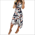 A black floral slim fit wrap dress featuring a bold geometric pattern in black white and blush pink with asymmetrical hemline