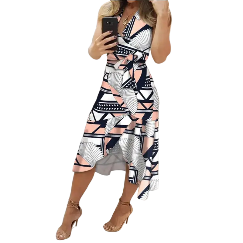 A black floral slim fit wrap dress featuring a bold geometric pattern in black white and blush pink with asymmetrical hemline