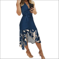 Navy blue slim fit floral dress with white gray leaf pattern, asymmetrical hemline, and matching waist belt wrap dress