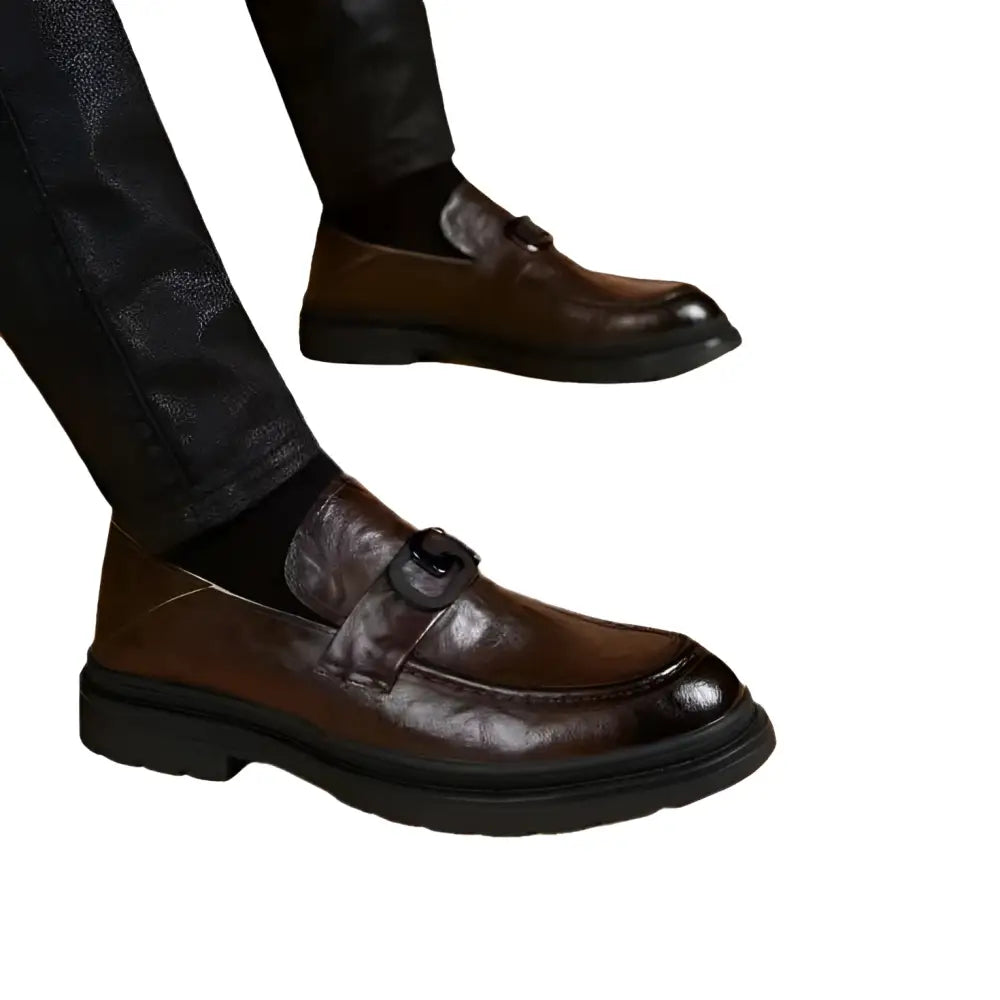 Black glossy business casual leather loafer with prominent buckle detail on the vamp for casual leather loafers use