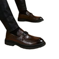 Brown leather casual loafers with black buckle and thick rubber sole for black glossy business casual leather style