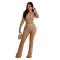 A shimmering black gold color mesh rhinestone two piece set with a high neck top and flared pants
