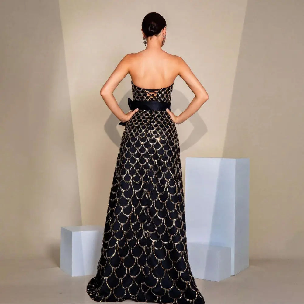 Black strapless large swing sequined evening dress with gold-scale embroidery and satin sash at the waist