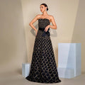 Black strapless large swing sequined evening dress with gold shimmering scale pattern and matching satin waist bow