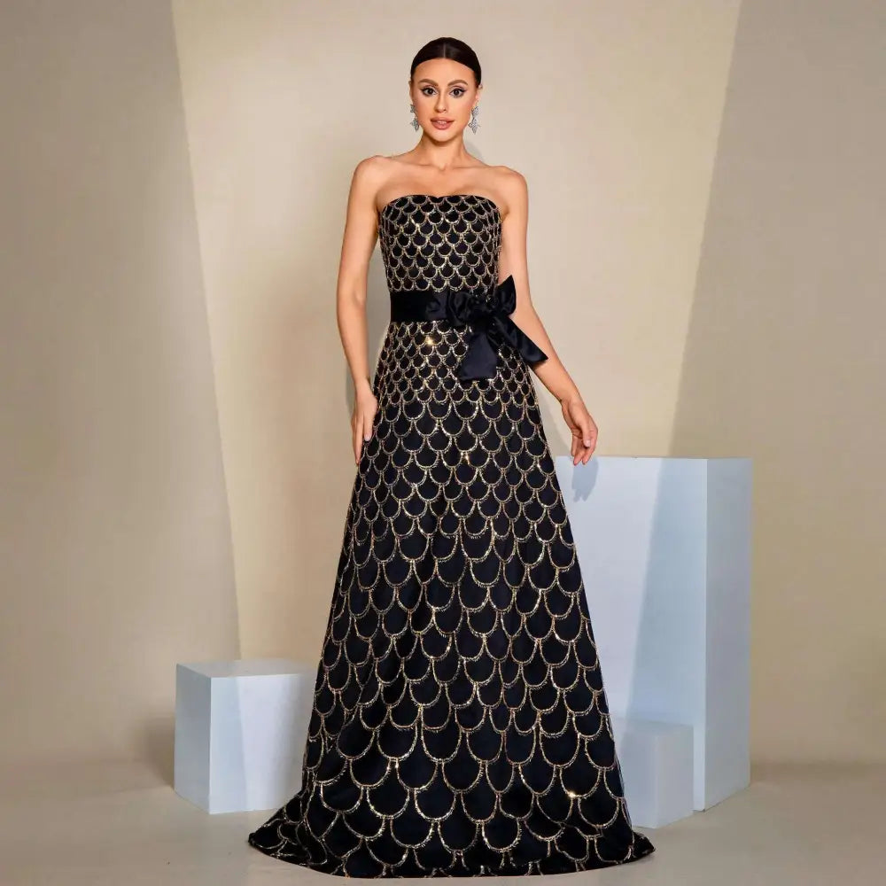Black strapless large swing sequined evening dress with shimmering gold fish-scale embroidery and satin bow at the waist