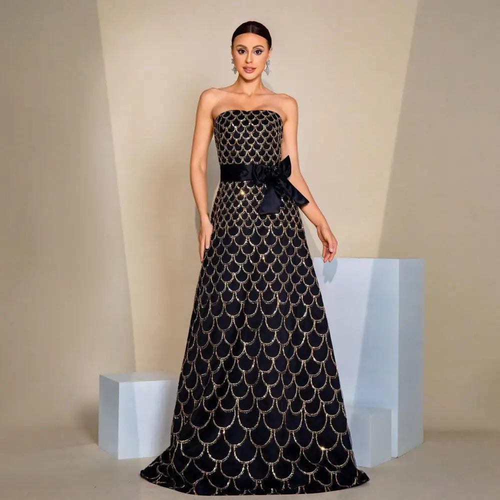 Black strapless large swing sequined evening dress with intricate gold-scale embroidery and satin bow at the waist