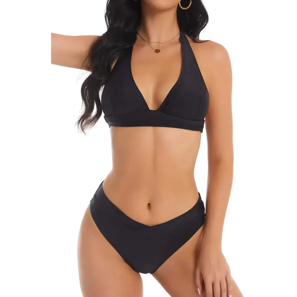 Black halter bikini set featuring a v-shaped neckline top and matching high cut bottoms in a sleek design