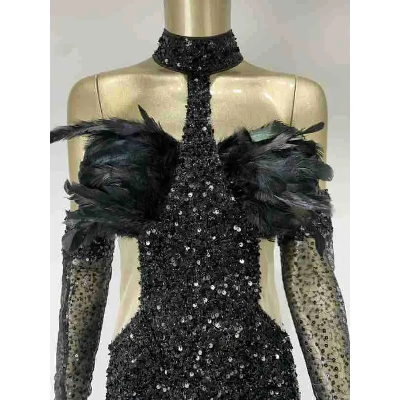 Black halter feather sequins short mini dress with black sequined fabric, feather shoulder accents, and sheer long sleeves
