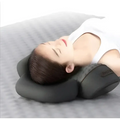 Black heated cervical pillow made of memory foam with contoured design and subtle brand logo for neck support wrap