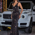 Black high slit sequined evening dress with shimmering black fabric deep v-neckline and gold side cutouts