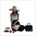 Black structured handbag with gold-tone clasp and handles complements luxury women’s fashion lace camisole outfits