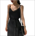Black lace camisole with lace trim and spaghetti straps showcasing luxury women’s fashion essentials