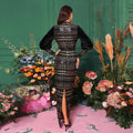 Black lace sequined maxi dress with round neck, black velvet material, gold sequin detailing, and high slit
