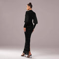 A sleek black lace round neck sequined maxi dress with long sleeves, fitted silhouette, and high slit