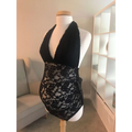 Black lace maternity halter neck shaping bodysuit with floral pattern displayed on a mannequin