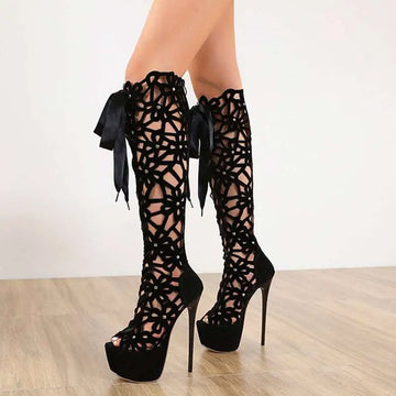 Black lace-up peep toe high heels featuring floral cutout patterns and satin ribbon ties on platform heels