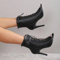 Black leather peep toe high heel pumps with lace-up ankle design, stiletto heel, and side buckle detail