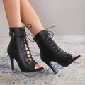 Black leather peep toe high heel pumps featuring lace-up ankle design with stiletto heel and open toe style