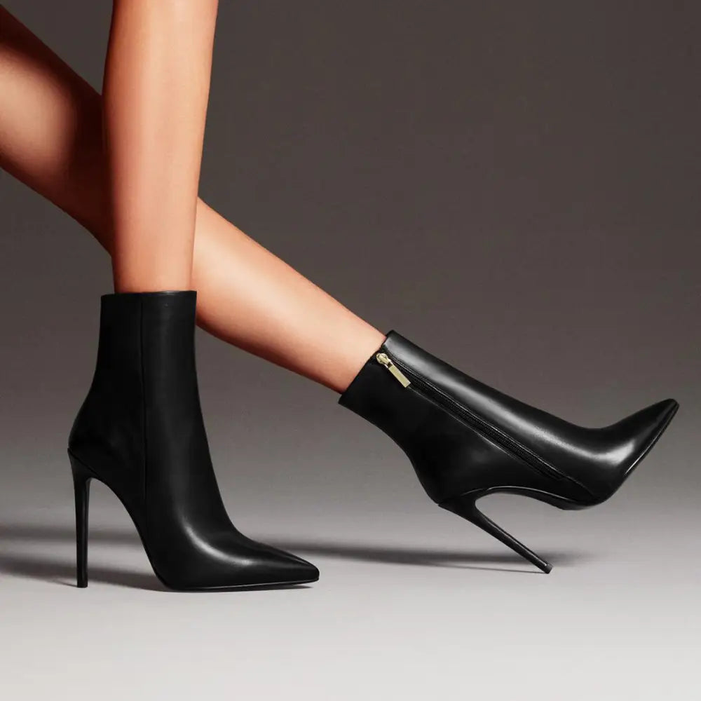 Black leather stiletto ankle boots with a sleek pointed toe and slender high heel for elegant wear