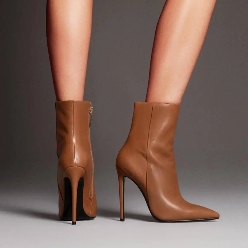 Tan leather stiletto ankle boots with sleek pointed toe and slender high heel perfect for formal wear