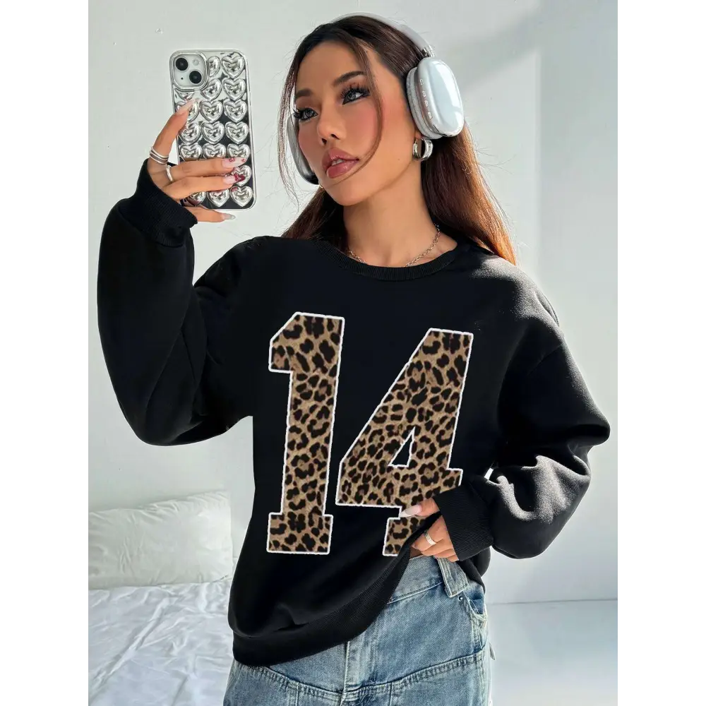 Black crew neck sweatshirt featuring a bold leopard print number 14 on the front for casual wear