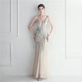 A shimmering silver mesh beaded bridal wedding dinner gown with plunging neckline and sheer illusion sleeves