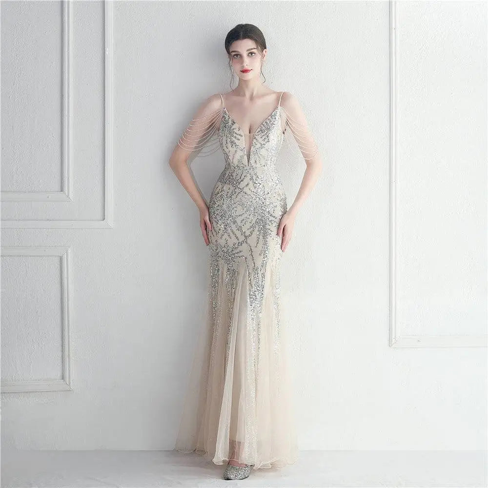 A shimmering silver mesh beaded bridal wedding dinner gown with plunging neckline and sheer illusion sleeves