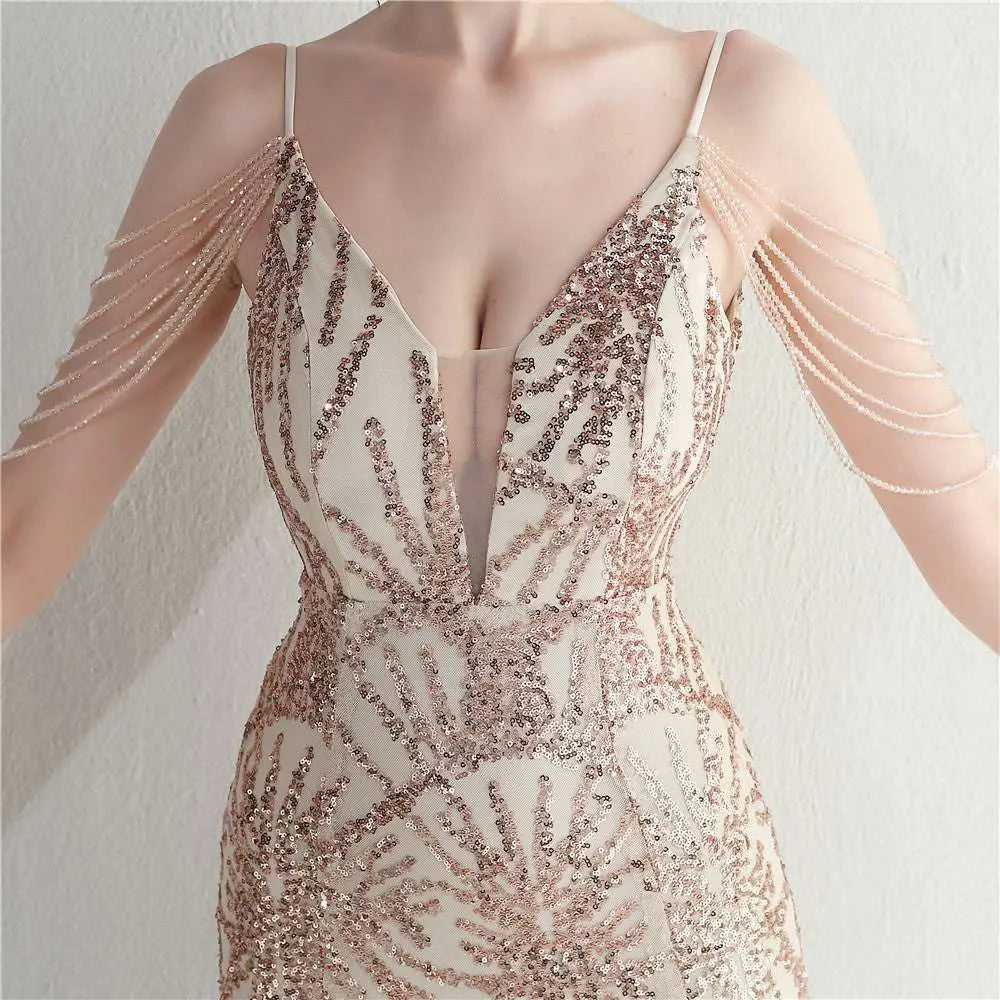 A shimmering rose gold sequined gown with delicate spaghetti straps and plunging v-neckline for bridal wedding dinner