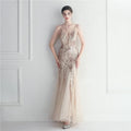 A shimmering champagne evening gown with intricate gold sequin patterns and delicate sheer fabric for bridal wedding dinner