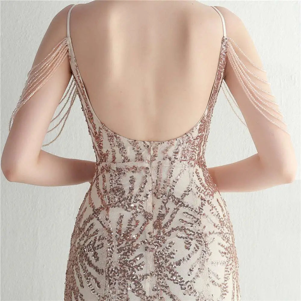 A shimmering rose gold mesh beaded bridal wedding dinner gown with delicate straps and cascading beaded shoulder chains