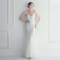 A white lace mermaid wedding gown with delicate beaded straps and a plunging v-neckline for bridal wedding dinner in black mesh beaded style