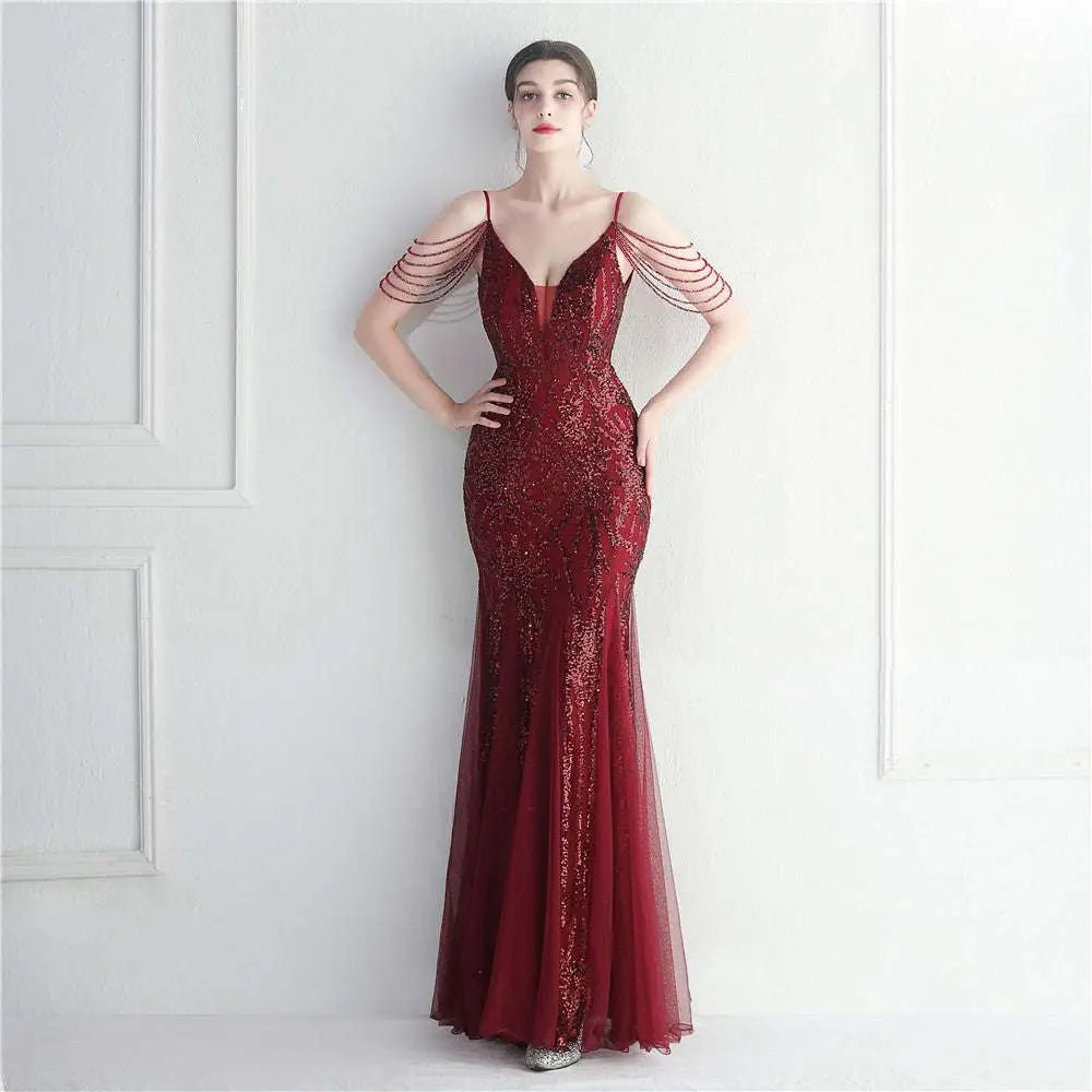 A shimmering burgundy mesh beaded bridal wedding gown with intricate sequins and delicate beaded shoulder straps