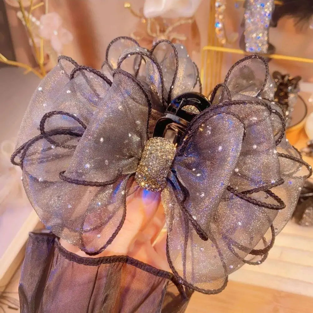 Black mesh rhinestone large korean style flower clip with a sheer bow and glittering gold rhinestone center