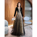 Elegant black moderator long sleeve annual party dress in black velvet with gold embroidery and a sheer layered skirt
