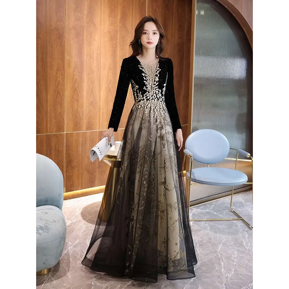 Elegant black moderator long sleeve annual party dress in black velvet with gold embroidery and a sheer layered skirt