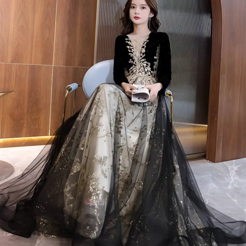 Elegant black moderator long sleeve annual party dress with velvet bodice, gold embroidery, and layered tulle skirt
