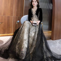 Elegant black moderator long sleeve annual party dress with velvet bodice, gold embroidery, and layered tulle skirt