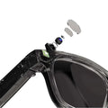 Black modern camera smart glasses with black frames, transparent lenses, purple accent, and visible internal camera components