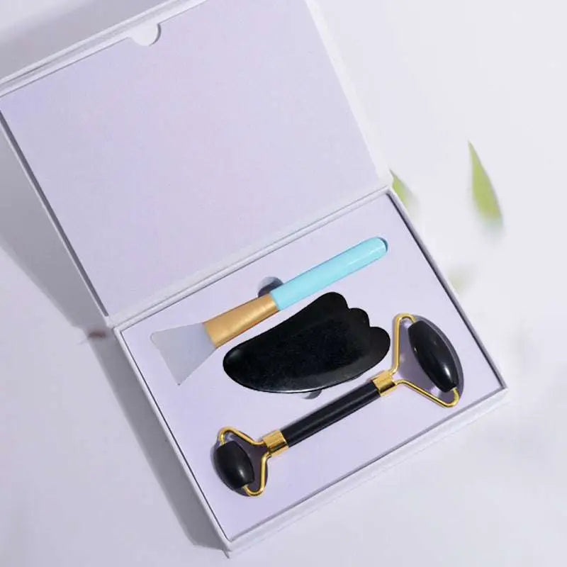 Black and gold facial roller with smooth rounded stone head for black obsidian beauty care massage jade roller use