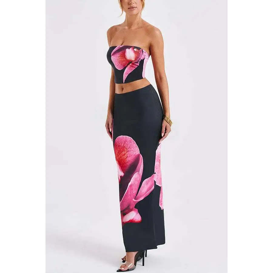 Black orchid fashion two-piece skirt set featuring a black strapless cropped top and vibrant pink orchid prints