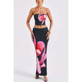 Black strapless top and high-waisted skirt set with vibrant pink orchid print in black orchid fashion vacation style