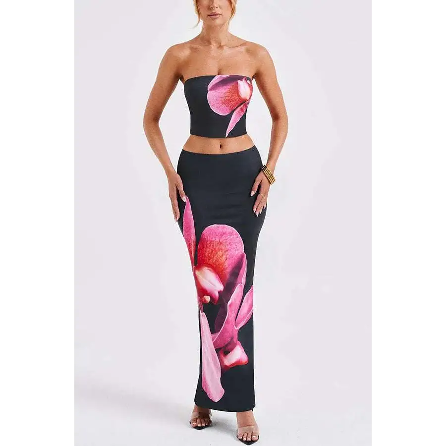 Black strapless top and high-waisted skirt set with vibrant pink orchid print in black orchid fashion vacation style