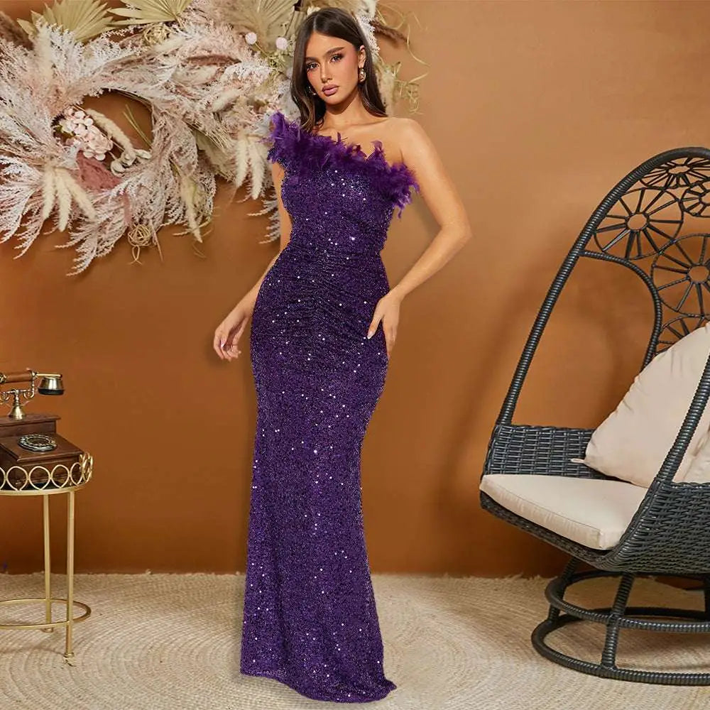 A shimmering purple evening gown with black paillette feather stitching sequin details and feather trim on the shoulder