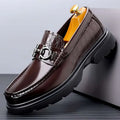 Brown crocodile-embossed leather loafer with metallic horsebit buckle and chunky sole for retro casual shoes