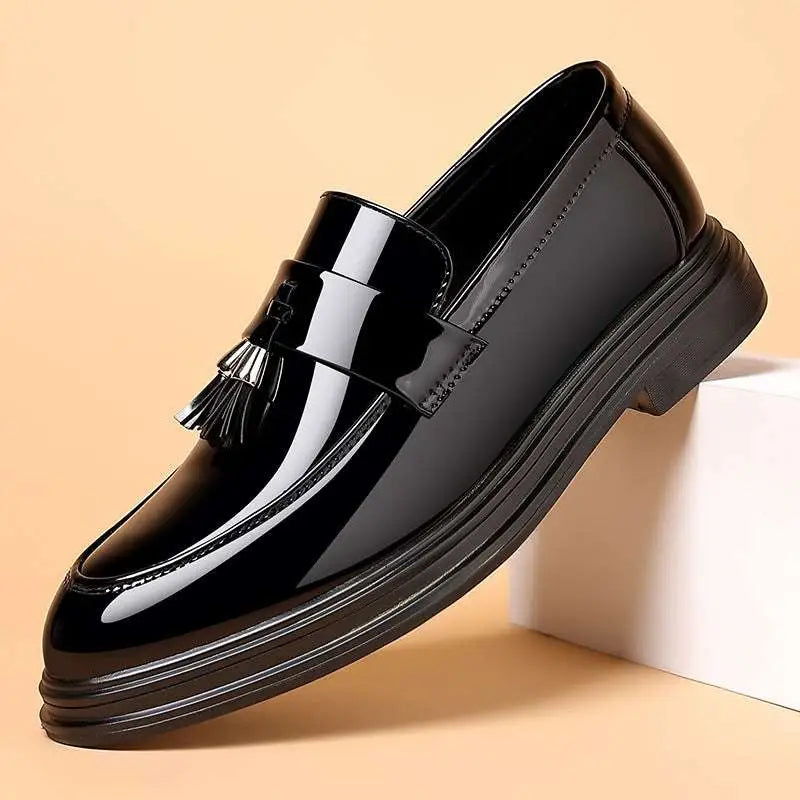 Black patent leather tassel loafer with glossy finish designed for business formal wear