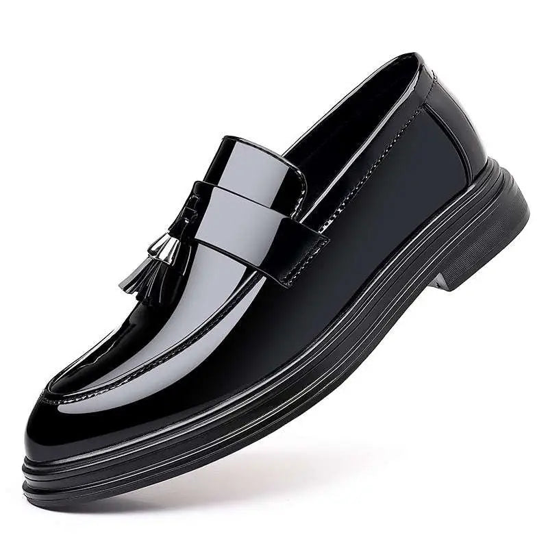 Black patent leather tassel loafers with glossy finish and thick sole for business formal wear