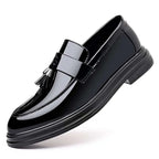 Black patent leather tassel loafer with glossy finish suitable for business formal wear shoes