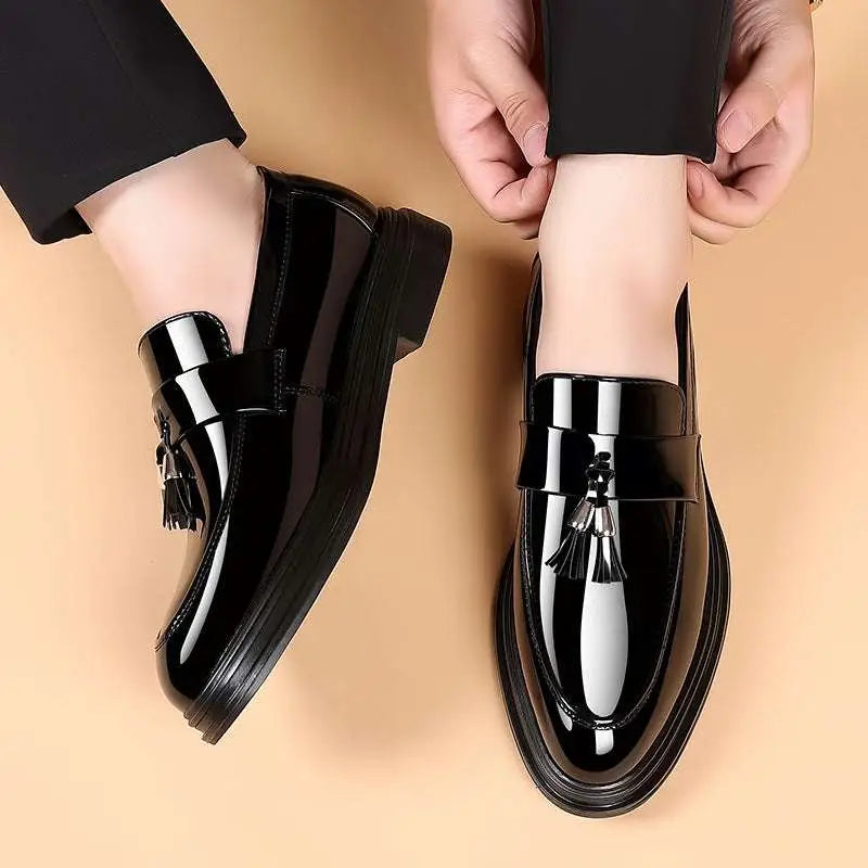 Black patent leather tassel business formal wear shoes with a glossy finish and decorative tassels on the front