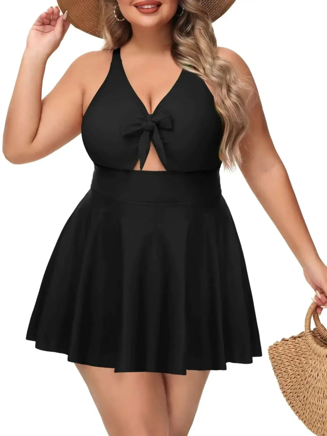 Black plus size one-piece swimsuit for curvy women with a halter neckline front bow detail and flared skirt featured in top plus size dresses and swimwear for curvy women in 2026.