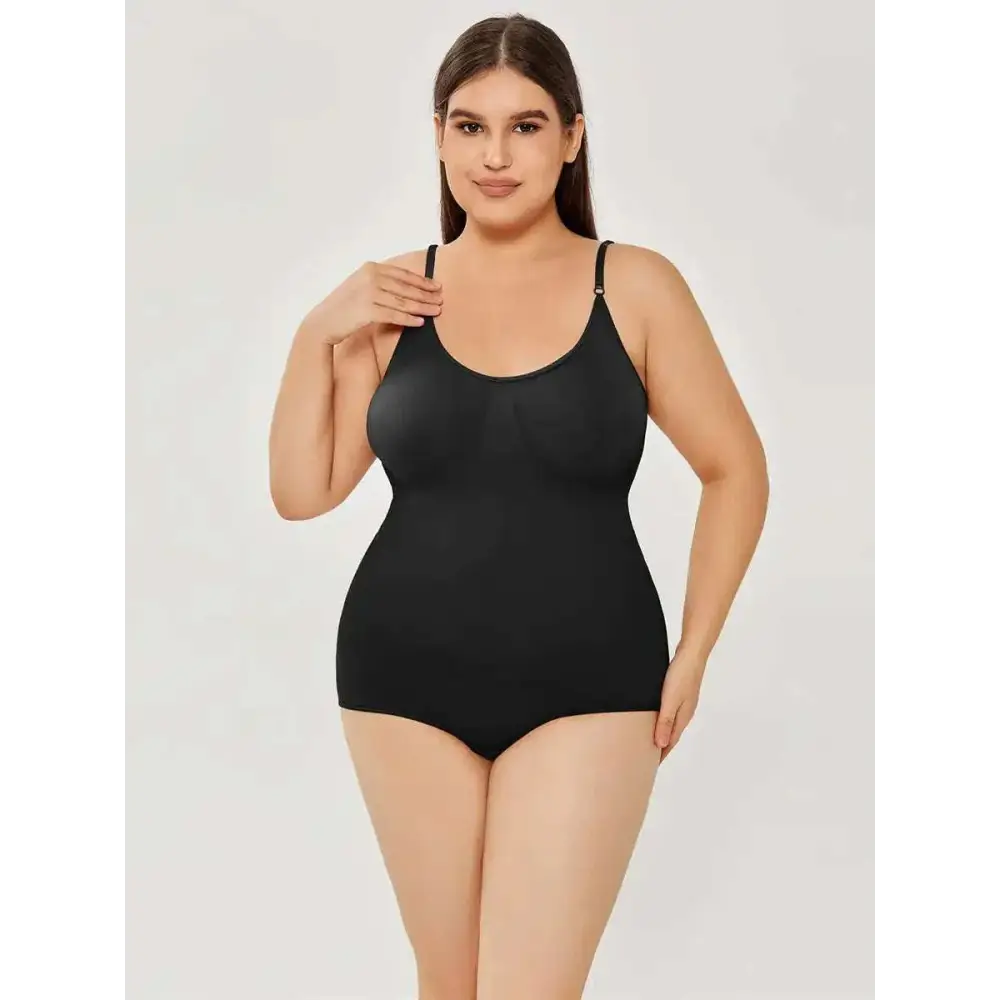 Black plus size women tummy control swimsuit in smooth black fabric with thin straps and form-fitting design